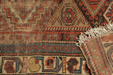 Antique Kurdish rug border detail with geometric hook motifs, woven reverse, and worn fringe.