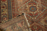 Worn madder red, sky blue geometric antique Kurdish rug with exposed foundation and tattered fringe.