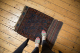 Hand-knotted antique Belouch rug corner, showing striped woven end and indigo, madder patterns.