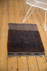 Antique Belouch rug's upper corner, showcasing the plain woven foundation and intricate pattern.