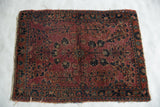 Antique Mohajeran Sarouk close-up: plum, navy, powder blue floral palmette pattern, visible wear.