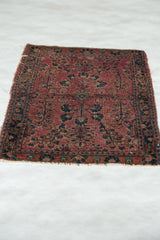 Antique Mohajeran Sarouk lower border: faded plum and blue blossomed floral motifs, with wear.