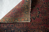 Hand-knotted foundation and worn edge of antique Mohajeran Sarouk rug, plum and blue motifs.