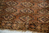 Antique Turkmen rug lower border, chestnut, navy, ivory geometric patterns, distinct pile wear, tattered fringe.
