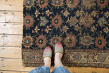 Antique Kurd rug, Veramin design in navy, red, beige, showing visible wear and tattered edge.