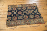 Visible wear to knot heads and tattered edge on navy blue Veramin motif, antique Kurd rug.
