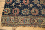 Tattered edge of an antique West Persian Kurd rug showing primitively drawn Veramin motifs.