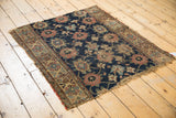 Worn corner of antique Kurd rug with navy, red, gold Veramin design, exposed foundation.