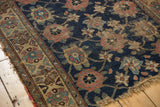 Fragmented antique Kurd rug: worn navy field, exposed knot heads, primitive Veramin design, tattered edge.