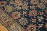 Antique Kurd rug detail, navy field Veramin design with madder florals, visible wear and tatter.