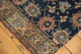 Antique Kurd rug fragment's tattered edge, navy field, Veramin motifs, and visible knot head wear.