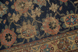Antique Kurd rug detail showing worn Veramin motif with navy, madder red, and beige foundation.