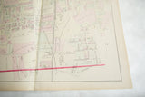 The central fold of an antique Woburn map showing railroad lines and hand-colored landowner plots.