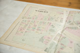 Antique Woburn map detail showing pastel-colored properties and streets around the town common.