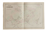Antique 1875 atlas map of Woburn, MA showing streets and color-tinted parcels on aged paper.