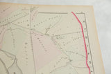 Angled close-up of the 1875 Woburn map showing printed landowner names and property lines.