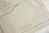 Printed scale and pastel-tinted property plots on the corner of the 1875 Woburn atlas map.