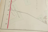 Angled detail of the 1875 Woburn map showing landowners' names and hand-colored property lines.