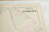 Title section of the 1875 Woburn atlas map with period typography and hand-colored land parcels.