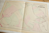 Title block and detailed property plots on an 1875 antique map of Woburn, MA.