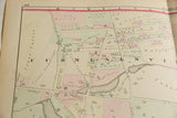 Detailed view of hand-colored property plots and landowner names on an antique Woburn map.