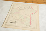 Perspective view of the antique Woburn atlas map highlighting the aged paper and frayed left edge.