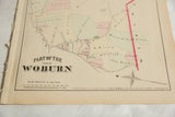 The 1875 G.M. Hopkins copyright and compass rose on an antique map of Woburn, Massachusetts.