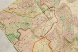 Hand-colored boundaries of Cambridge and Brighton on a creased antique 1874 Boston map.