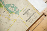 Angled view of the title block on a vintage pull-down map of Worcester, Massachusetts.