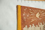 Detail of the yellow stitched edge and music note graphic on a terra-cotta felt pennant.