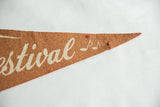 Pointed tip of the terracotta felt pennant with musical notes and a visible pinhole.