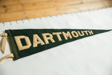 Antique green felt Dartmouth pennant with beige DARTMO letters and fabric ties.