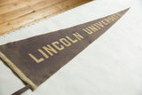 Antique Lincoln University felt pennant, with cream stitched lettering on muted purple felt.