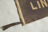 Antique Lincoln University felt pennant with tan sewn edge trim and attached ties.