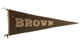 Vintage Brown University felt pennant, dark brown with beige letters, showing historic patina.