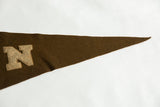 Vintage Brown University pennant's brown felt tip, highlighting aged texture and subtle wear.