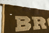 Brown University vintage felt pennant showing 'BR' letters with aged patina.