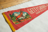 Vintage red felt pennant showing the leaping deer graphic and yellow bound edge.