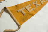 Mustard yellow antique Texas felt pennant, circa 1920s, with beige appliqued letters.