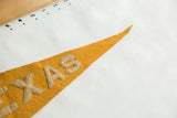 Antique Texas felt pennant tip featuring mustard yellow wool and sewn beige letters.