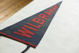 Detail of vintage Wilbraham Academy felt pennant: red WILBRAHAM letters on blue.