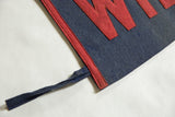 Detail of antique Wilbraham Academy felt pennant's blue tie and stitched red trim.