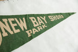 Creased texture of the green vintage felt flag with tan New Bay Shore Park lettering.