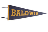Vintage Baldwin felt pennant with yellow block lettering on a navy blue field, 11x29.