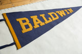 Vintage Baldwin felt pennant, yellow block lettering on deep blue, with gold trim.
