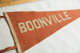 Close view of the aged wool texture and sewn letters of an antique Boonville pennant.