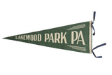 Vintage Lakewood Park, PA, felt pennant in green with cream serif lettering and blue ties.
