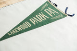 Close-up of the blue felt ties and off-white border on the vintage green wool pennant.