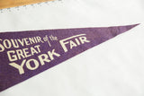 Purple felt vintage pennant featuring white 'FAIR' text, showcasing soft wool texture.