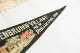 Angled view of the Schoenbrunn Village felt pennant's printed text and texture.